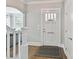 Bright foyer with a white front door and hardwood floors featuring stairs and a glimpse into the living room at 2804 Park Rd, Charlotte, NC 28209