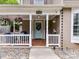 Inviting front porch with decorative hanging plants and a charming, painted front door at 2804 Park Rd, Charlotte, NC 28209