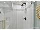 Sleek shower featuring white subway tile, a glass enclosure, and modern fixtures at 2804 Park Rd, Charlotte, NC 28209