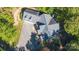 Drone shot of a house with a gray roof and spacious driveway amidst leafy trees, showcasing the property's layout at 2817 Lakefront Dr, Belmont, NC 28012