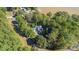 Stunning aerial view of home nestled among lush trees near the lake with road access and ample privacy at 2817 Lakefront Dr, Belmont, NC 28012