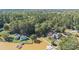Expansive aerial view of a lakeside home with a private boat dock, wooded surroundings, and mature trees at 2817 Lakefront Dr, Belmont, NC 28012