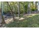 Wooded backyard with mature trees, showcasing natural landscaping and offering privacy at 2817 Lakefront Dr, Belmont, NC 28012
