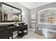 Modern bathroom with a soaking tub, double vanity, and sleek fixtures at 2817 Lakefront Dr, Belmont, NC 28012