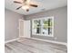 Serene bedroom featuring wood floors, a ceiling fan, and a lake view from the window at 2817 Lakefront Dr, Belmont, NC 28012