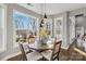 Bright breakfast nook featuring a round table, four chairs, and bay windows with wooded views at 2817 Lakefront Dr, Belmont, NC 28012