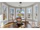 Bright breakfast nook featuring a round table, four chairs, and bay windows with wooded views at 2817 Lakefront Dr, Belmont, NC 28012