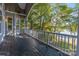 Outdoor deck with wood flooring and railing overlooking a lake and trees at 2817 Lakefront Dr, Belmont, NC 28012