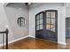 Entryway featuring double doors, wood floors, and gray walls with white trim at 2817 Lakefront Dr, Belmont, NC 28012