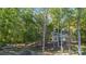 Beautiful lakefront home features wall of windows and private access to lake, surrounded by mature trees at 2817 Lakefront Dr, Belmont, NC 28012