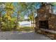 Close-up of a rustic stone fireplace on an outdoor patio, overlooking the lake, perfect for cozy gatherings at 2817 Lakefront Dr, Belmont, NC 28012