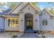 Gray two-story home with a black double door and sidelight windows with steps leading to the door at 2817 Lakefront Dr, Belmont, NC 28012