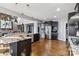 Open concept kitchen with stainless appliances, stone fireplace, granite countertops and hardwood floors at 2817 Lakefront Dr, Belmont, NC 28012