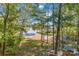 Scenic lake view through mature trees, showcasing waterfront property with serene and natural landscaping at 2817 Lakefront Dr, Belmont, NC 28012