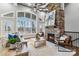 Bright living room with vaulted ceilings, a stone fireplace, hardwood floors and large windows at 2817 Lakefront Dr, Belmont, NC 28012
