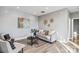 Neutral-toned living room with stylish furniture, wood flooring, and decorative accents at 2817 Lakefront Dr, Belmont, NC 28012