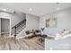 Spacious living area with wood floors, comfortable seating, and staircase at 2817 Lakefront Dr, Belmont, NC 28012