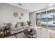 Bright and stylish living area with neutral tones, wood floors and sliding glass doors to a lake view at 2817 Lakefront Dr, Belmont, NC 28012
