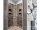 Modern walk-in shower featuring stylish tile work, dual shower heads and recessed shelves at 2817 Lakefront Dr, Belmont, NC 28012
