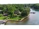 Beautiful aerial view of waterfront property with mature trees and boat dock at 2818 Cherry Ln, Denver, NC 28037