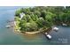 Island estate with lush trees, a boat house and dock highlighted by lot lines at 2818 Cherry Ln, Denver, NC 28037