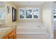 Bright bathroom features a soaking tub with jets and granite countertop at 2818 Cherry Ln, Denver, NC 28037