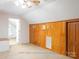 Carpeted bedroom features wood paneled walls and a ceiling fan at 2818 Cherry Ln, Denver, NC 28037