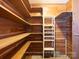 Walk-in closet with wood shelving and an adjustable shelving unit at 2818 Cherry Ln, Denver, NC 28037