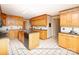Traditional kitchen featuring wooden cabinetry, an island, and checkered tile flooring at 2818 Cherry Ln, Denver, NC 28037
