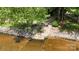 Waterfront property featuring a concrete boat launch and riprap shoreline at 2818 Cherry Ln, Denver, NC 28037