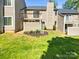 Townhome backyard with a small deck, patio, and manicured lawn at 3143 Windbluff Dr, Charlotte, NC 28277