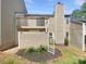 Exterior shot of a townhome backyard with a small deck and landscaped yard at 3143 Windbluff Dr, Charlotte, NC 28277