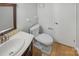 Compact, neutral bathroom with a modern sink, marble countertop and a toilet, creating a tidy space at 3143 Windbluff Dr, Charlotte, NC 28277