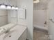 Bright, clean bathroom with a single sink vanity, neutral tiles, and a shower-tub combo at 3143 Windbluff Dr, Charlotte, NC 28277