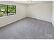 Neutral bedroom featuring carpeting, a large window and ample space with potential for a personalized design at 3143 Windbluff Dr, Charlotte, NC 28277