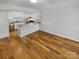 Open concept with hardwood floors, bright kitchen with granite counters and stainless steel appliances flowing into an open area at 3143 Windbluff Dr, Charlotte, NC 28277