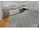 Modern kitchen with stainless steel appliances, granite countertops, and white cabinetry perfect for cooking and entertaining at 3143 Windbluff Dr, Charlotte, NC 28277