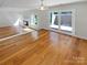 Spacious living room with fireplace, hardwood floors, and sliding glass doors at 3143 Windbluff Dr, Charlotte, NC 28277
