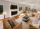 Cozy living room with a fireplace, hardwood floors, and a dining area, virtually staged for a modern look at 3143 Windbluff Dr, Charlotte, NC 28277