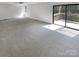 Living room featuring carpeted flooring and a sliding glass door to the deck at 3143 Windbluff Dr, Charlotte, NC 28277
