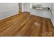Bright, open-concept living room with hardwood floors and a modern kitchen at 3143 Windbluff Dr, Charlotte, NC 28277