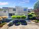 Inviting townhome featuring a neutral facade, manicured landscaping, and an attached front entry for added curb appeal at 3143 Windbluff Dr, Charlotte, NC 28277