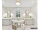 Bright bathroom featuring double vanities, a soaking tub, and stylish lighting fixtures at 4015 Pritchard Pl, Fort Mill, SC 29715