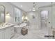 Elegant bathroom featuring marble floors, soaking tub, separate vanities, and contemporary lighting at 4015 Pritchard Pl, Fort Mill, SC 29715