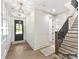 Inviting foyer with hardwood floors, modern lighting, staircase, and stylish front door at 4015 Pritchard Pl, Fort Mill, SC 29715