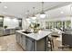 Open-concept kitchen with a large island, stainless steel appliances, and seamless flow to the living area at 4015 Pritchard Pl, Fort Mill, SC 29715