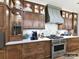 A modern kitchen with custom cabinets, stainless steel appliances, and a designer range hood at 4015 Pritchard Pl, Fort Mill, SC 29715