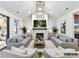 Open-concept living room with white painted brick fireplace and large screen television at 4015 Pritchard Pl, Fort Mill, SC 29715