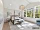 The primary bedroom has a four-poster bed, vaulted ceilings, and many windows looking out to the trees at 4015 Pritchard Pl, Fort Mill, SC 29715