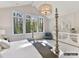 View of the sun-drenched primary bedroom, with a four-poster bed and vaulted ceilings at 4015 Pritchard Pl, Fort Mill, SC 29715